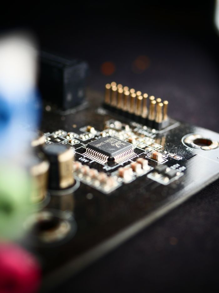 Offerings Detailed view of a microchip on a circuit board, showcasing modern electronics.