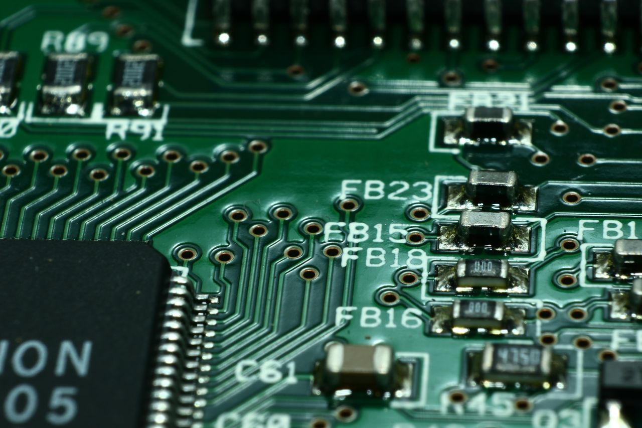 Offerings Detailed macro view of a circuit board showcasing microchips and electronic components.